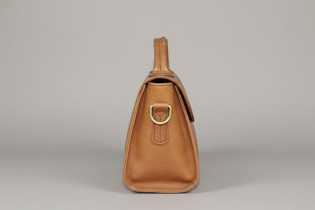 Stylish brown leather flap bag displayed